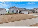 Attractive one-story house featuring a two-car garage and an American flag in the yard at 242 Cordova St, Woodstock, GA 30189
