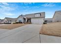 Alluring one-story house with a concrete driveway leading to a two-car garage at 242 Cordova St, Woodstock, GA 30189