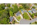 Aerial view of a home with a pool surrounded by lush greenery in a residential neighborhood at 3105 Birchton St, Johns Creek, GA 30022