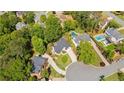 Aerial view of the neighborhood showing a home with mature trees and backyard swimming pools at 3105 Birchton St, Johns Creek, GA 30022