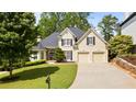 Charming two-story home featuring a manicured front lawn and a two-car garage at 3105 Birchton St, Johns Creek, GA 30022