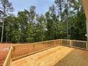 New wood deck with wood railings, overlooking a partially wooded lot at 3294 Mill Forest Dr, Conyers, GA 30094