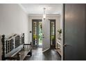 Elegant foyer with a dark tile floor, white walls, and a view of the front door that leads out to the porch at 3400 Bonds Lake Nw Rd, Conyers, GA 30012