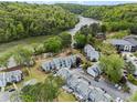 Scenic aerial view of townhome community nestled along a serene river at 1021 Riverbend Club Se Dr, Atlanta, GA 30339