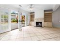 Cozy living room with fireplace, built-in shelves, and access to outdoor deck at 1021 Riverbend Club Se Dr, Atlanta, GA 30339