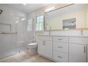 Modern bathroom features a glass-enclosed shower, dual sinks, and updated vanity at 3320 Woodleaf Way, Marietta, GA 30062