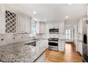 Updated kitchen boasts granite countertops, stainless steel appliances, and custom cabinets at 3320 Woodleaf Way, Marietta, GA 30062