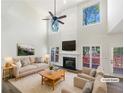 Bright living room featuring soaring ceilings, fireplace, and serene views of the surrounding landscape at 6105 Ivey Hill Dr, Cumming, GA 30040