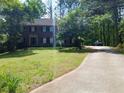 Traditional two-story brick home with a manicured lawn and long driveway at 921 Eagle Crossing Dr, Lawrenceville, GA 30044