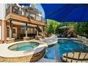 Outdoor living space with an in-ground pool, spa, lounge chairs, and a covered patio at 3115 Corsair Curv, Cumming, GA 30040