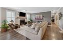 Elegant living room features a cozy fireplace, hardwood floors, and neutral paint colors at 103 Mill Pond Rd, Roswell, GA 30076