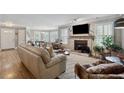 Spacious living room featuring a stone fireplace and stylish furniture on hardwood floors at 103 Mill Pond Rd, Roswell, GA 30076