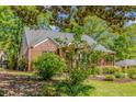 Well-maintained brick home with a lush yard, mature trees, and a charming covered porch at 1256 Spring Valley Ne Ln, Atlanta, GA 30306