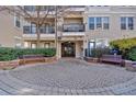 Inviting building entrance with manicured landscaping, benches, and secure gate providing a welcoming arrival at 1850 Cotillion Dr # 4204, Dunwoody, GA 30338