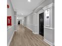Clean and well-maintained hallway featuring modern lighting, wood-style floors, and unit number for easy navigation at 1850 Cotillion Dr # 4204, Dunwoody, GA 30338