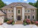 Elegant brick home with beautiful landscaping and a grand entrance at 2120 Blackheath Trce, Alpharetta, GA 30005