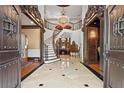 Grand foyer boasting a sweeping staircase and elegant marble flooring at 2120 Blackheath Trce, Alpharetta, GA 30005