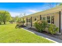 Inviting covered front porch with decorative shutters and lush landscaping at 63 Seminole Ne Rd, Cartersville, GA 30121