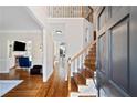 Inviting foyer with hardwood floors, staircase, and views into living spaces at 720 Lakeglen Dr, Suwanee, GA 30024