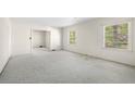 Spacious living room with neutral carpet and ample natural light from large windows at 1715 E Clifton Ne Rd, Atlanta, GA 30307
