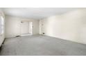Spacious living room featuring neutral carpet, a window, and an open doorway to another room at 1715 E Clifton Ne Rd, Atlanta, GA 30307