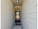Inviting entryway featuring a dark wood door with glass insert and sidelights, and light colored siding at 262 Quay Dr, Lawrenceville, GA 30044