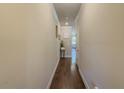 Bright hallway with hardwood floors, neutral paint, and access to other rooms in the home at 262 Quay Dr, Lawrenceville, GA 30044