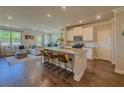 Open-concept kitchen with granite countertops, stainless steel appliances, and island seating at 262 Quay Dr, Lawrenceville, GA 30044