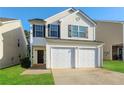Charming two-story home with a two-car garage and freshly cut lawn at 7503 Garnet Dr, Jonesboro, GA 30236