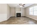 Bright living room features a fireplace, large window, and modern flooring at 7503 Garnet Dr, Jonesboro, GA 30236