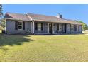 Inviting single-story home with a well-maintained lawn and dark shutters at 95 Graystone Dr, Covington, GA 30014