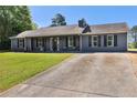 Attractive single-story home featuring a long driveway and well-kept lawn at 95 Graystone Dr, Covington, GA 30014