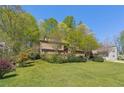 Charming two-story home with a lawn and mature landscaping surrounded by trees providing shade and privacy at 1735 Little Willeo Rd, Marietta, GA 30068