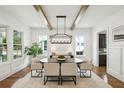 Elegant dining room with hardwood floors, wood beams, designer lighting, and large windows at 2193 Virginia Ne Pl, Atlanta, GA 30305