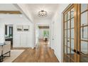 Bright hallway with hardwood floors, decorative lighting, wainscoting, and glass French doors at 2193 Virginia Ne Pl, Atlanta, GA 30305