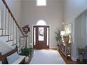 Grand foyer featuring a soaring ceiling, hardwood floors, staircase, and stylish decor at 2227 Austin Lake Se Dr, Smyrna, GA 30082