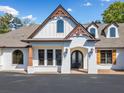 Beautiful home entrance featuring an arched doorway, stone accents, and manicured landscaping at 3920 Maybreeze Rd, Marietta, GA 30066