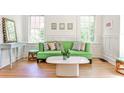 Bright living room with hardwood floors, complemented by a stylish green sofa and an abundance of natural light at 272 Rumson Ne Rd, Atlanta, GA 30305