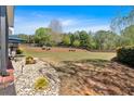 Expansive backyard with mature trees, wooden fence, and well-maintained lawn, perfect for outdoor activities at 541 Lombard St, Marietta, GA 30064