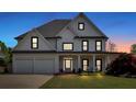 Stunning two-story home featuring a manicured lawn and a welcoming front porch with white rocking chairs at 541 Lombard St, Marietta, GA 30064