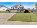 Beautiful two-story home featuring a three-car garage, welcoming porch, and meticulously maintained lawn at 541 Lombard St, Marietta, GA 30064