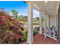 Cozy front porch with classic columns and comfortable seating overlooking the lush landscaping at 541 Lombard St, Marietta, GA 30064
