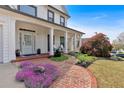 Inviting front porch with brick walkway, colorful flowers, and Adirondack chairs for relaxing at 541 Lombard St, Marietta, GA 30064