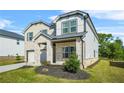 Eye-level of a modern two-story house with brick and gray siding, a two-car garage, and a landscaped yard at 802 Milo Bay St, Loganville, GA 30052