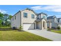 Side view of an attractive two-story house with brick and vinyl siding, a two-car garage, and a well-kept lawn at 802 Milo Bay St, Loganville, GA 30052