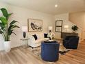 Cozy living room showcasing a modern couch, stylish art, and hardwood floors at 2674 Ne Almand Ne Ln, Conyers, GA 30013