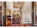 Grand foyer with soaring ceilings, hardwood floors, and a sweeping staircase at 13230 Addison Rd, Roswell, GA 30075