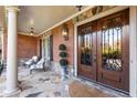 Charming front porch with stone flooring, detailed double doors, and stylish seating at 13230 Addison Rd, Roswell, GA 30075