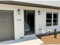 Exterior view of a home with an attached garage, showcasing modern lighting fixtures and a 0% down payment sign at 1341 E Atlanta E Rd, Stockbridge, GA 30281