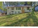 Attractive home with front yard landscaping on a grassy hill at 1346 Wichita Sw Dr, Atlanta, GA 30311